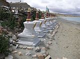 Tibet Kailash 07 Manasarovar 03 Seralung 8 Chortens A row of white chortens frame the shore of Lake Manasarovar next to Seralung Gompa.